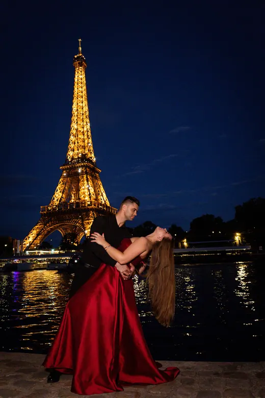 Photograph from the Couple — red dress at night session in Paris by Anna